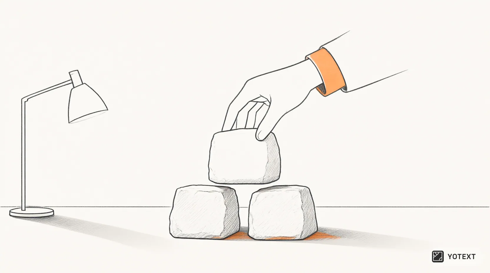 Three stone blocks arranged to form a stable pyramid on an office desk, with one hand placing the top block onto the two lower supports to demonstrate balance.